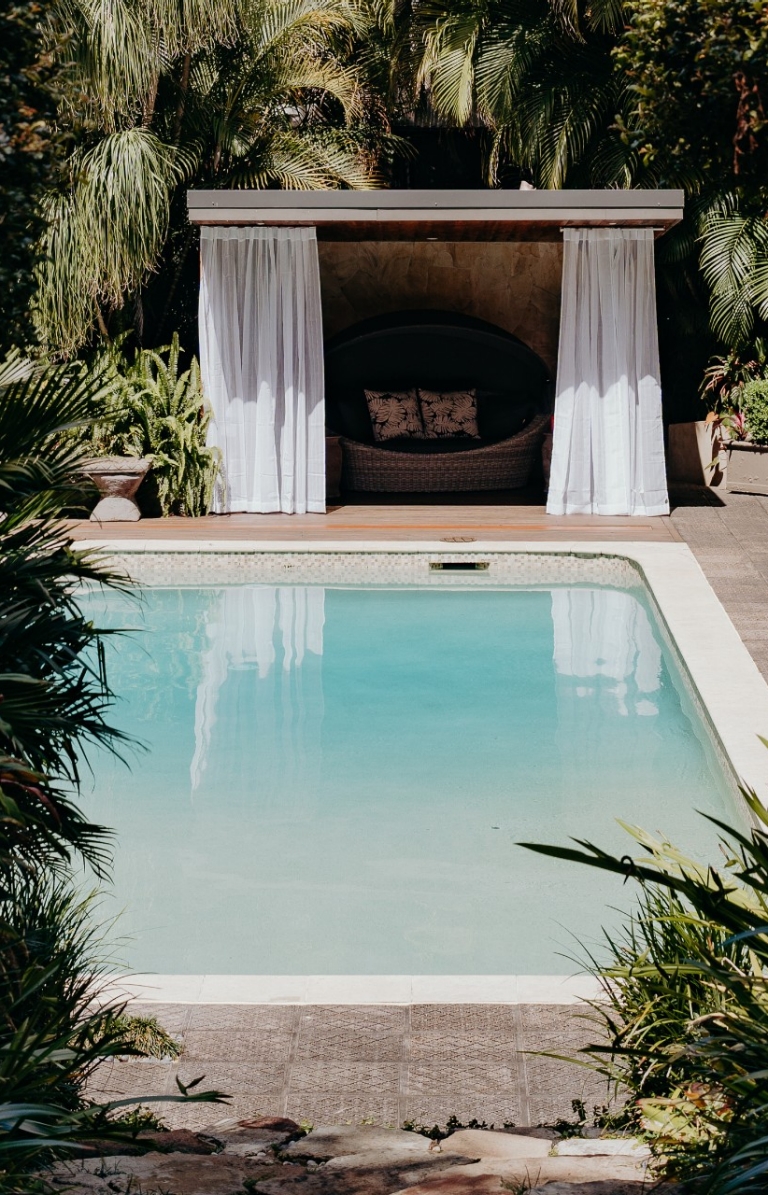 View through trees towards a pool and cabana surrounded by greenery at Gaia Retreat & Spa, Byron Bay, New South Wales © Gaia Retreat & Spa View through trees towards a pool and cabana surrounded by greenery at Gaia Retreat & Spa, Byron Bay, New South Wales © Gaia Retreat & Spa