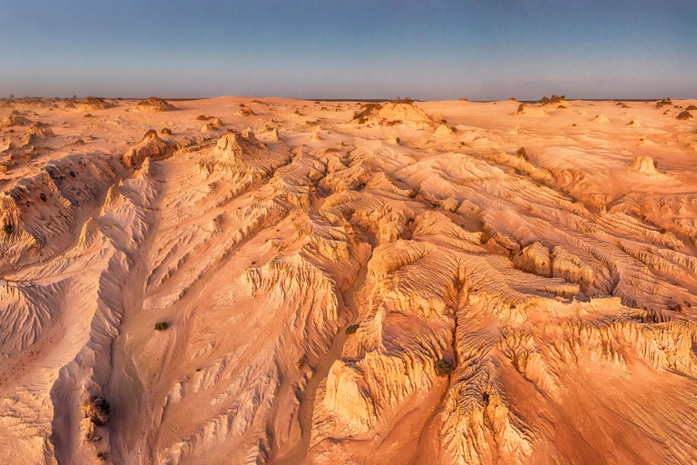 Aerial view over the rugged sand and clay formations of the Walls of China, Mungo National Park, New South Wales © Destination NSW Aerial view over the rugged sand and clay formations of the Walls of China, Mungo National Park, New South Wales © Destination NSW