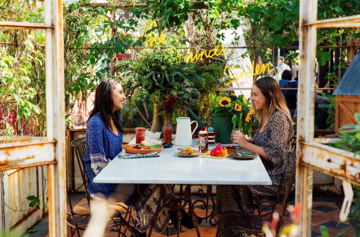 Two women enjoying a meal at The Grounds of Alexandria, Sydney, New South Wales © Destination NSW Two women enjoying a meal at The Grounds of Alexandria, Sydney, New South Wales © Destination NSW