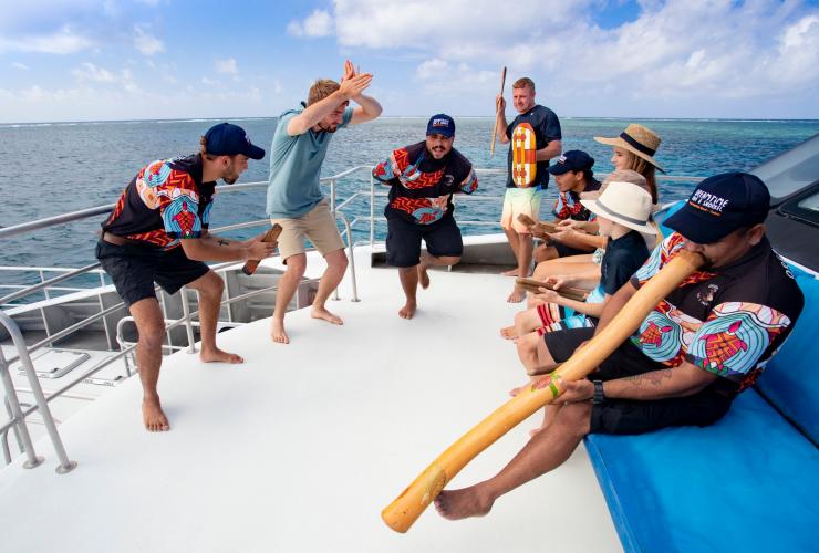 Visitors participate in a welcome ceremony aboard a Dreamtime Dive and Snorkel tour © Tourism and Events Queensland Visitors participate in a welcome ceremony aboard a Dreamtime Dive and Snorkel tour © Tourism and Events Queensland