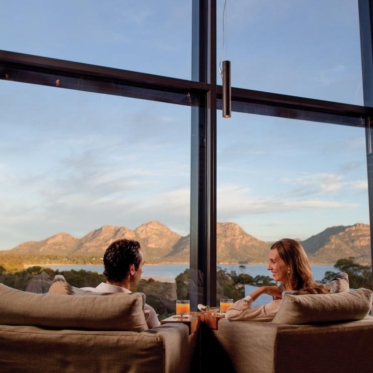 Couple relaxing in lounge with view over Freycinet National Park © Saffire Freycinet Couple relaxing in lounge with view over Freycinet National Park © Saffire Freycinet