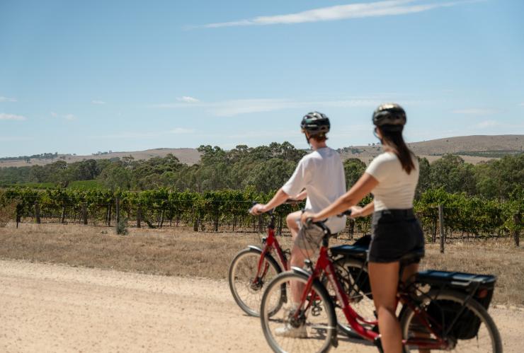A couple riding bikes through the vineyards along the Riesling Trail, Clare Valley, South Australia © South Australian Tourism Commission A couple riding bikes through the vineyards along the Riesling Trail, Clare Valley, South Australia © South Australian Tourism Commission