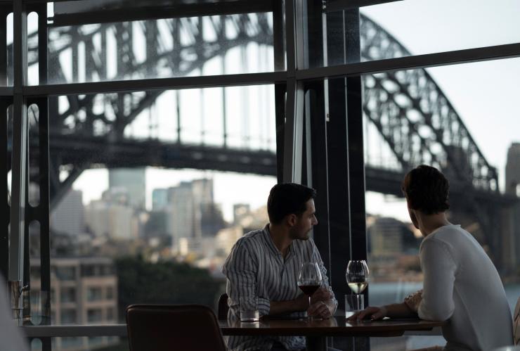 Couple enjoying wine with views across Sydney Harbour towards the Sydney Harbour Bridge from Quay Restaurant © Destination NSW Couple enjoying wine with views across Sydney Harbour towards the Sydney Harbour Bridge from Quay Restaurant © Destination NSW