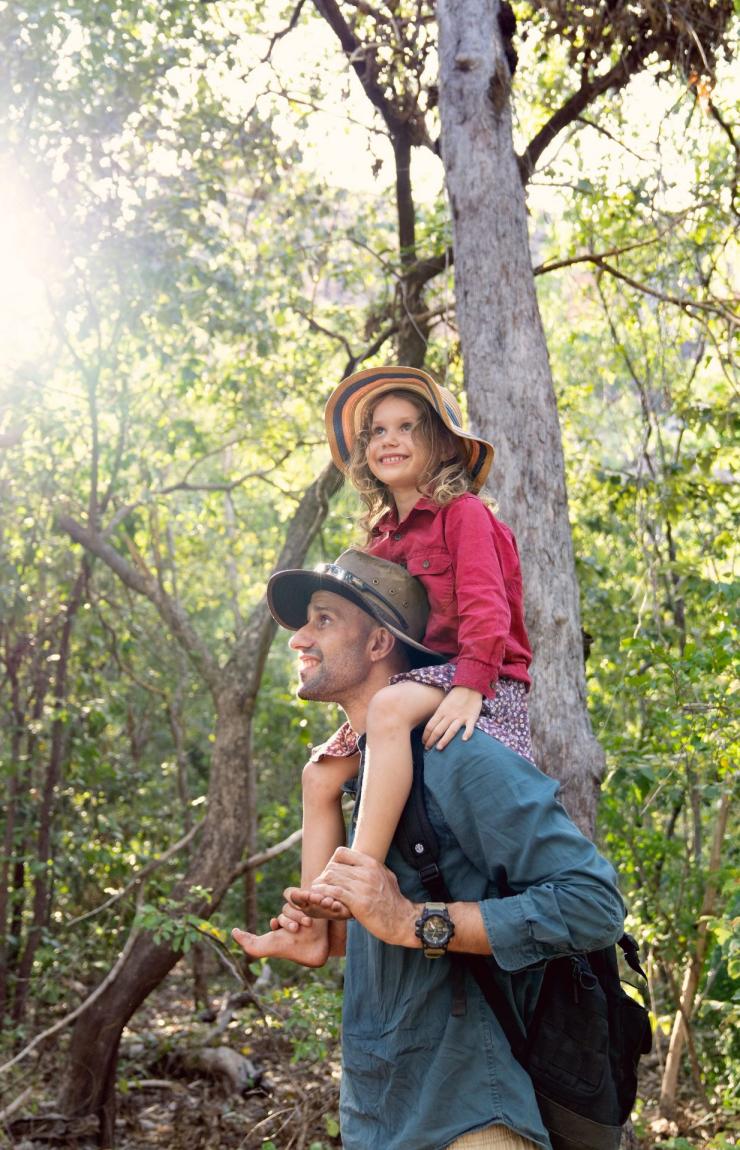 A child sits on her father's shoulders in the forest on a tour with Offroad Dreaming, Kakadu National Park, Northern Territory © Tourism Australia A child sits on her father's shoulders in the forest on a tour with Offroad Dreaming, Kakadu National Park, Northern Territory © Tourism Australia