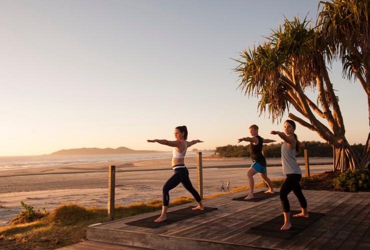 People doing sunrise yoga by the beach at Elements of Byron Bay Resort & Spa in Byron Bay © Destination NSW People doing sunrise yoga by the beach at Elements of Byron Bay Resort & Spa in Byron Bay © Destination NSW