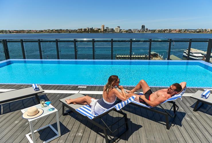 Couple sunbathe by rooftop pool at DoubleTree by Hilton Waterfront, Perth, Western Australia © DoubleTree by Hilton Perth Waterfront Couple sunbathe by rooftop pool at DoubleTree by Hilton Waterfront, Perth, Western Australia © DoubleTree by Hilton Perth Waterfront