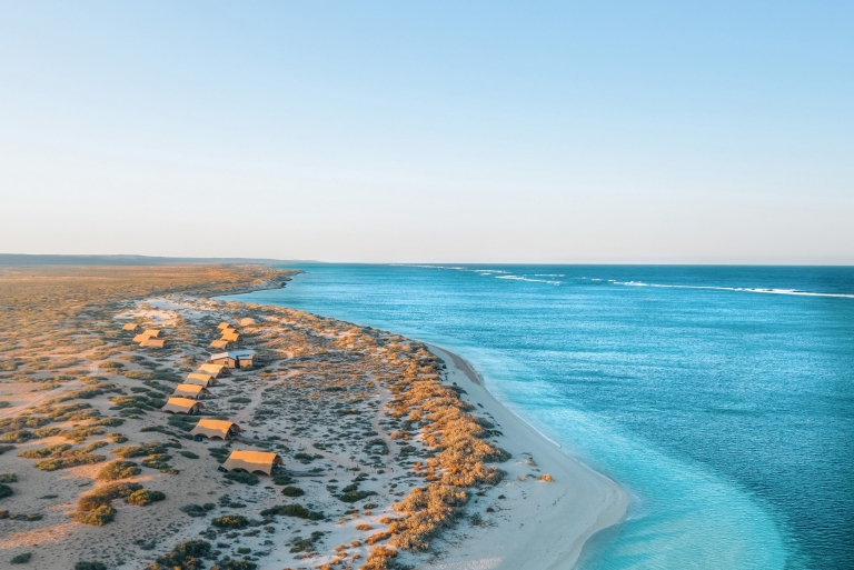 Aerial view of Sal Salis luxury accommodation amid the sand dunes on the coast of the bright blue waters of Ningaloo Reef, Western Australia © Sal Salis Ningaloo Reef Aerial view of Sal Salis luxury accommodation amid the sand dunes on the coast of the bright blue waters of Ningaloo Reef, Western Australia © Sal Salis Ningaloo Reef