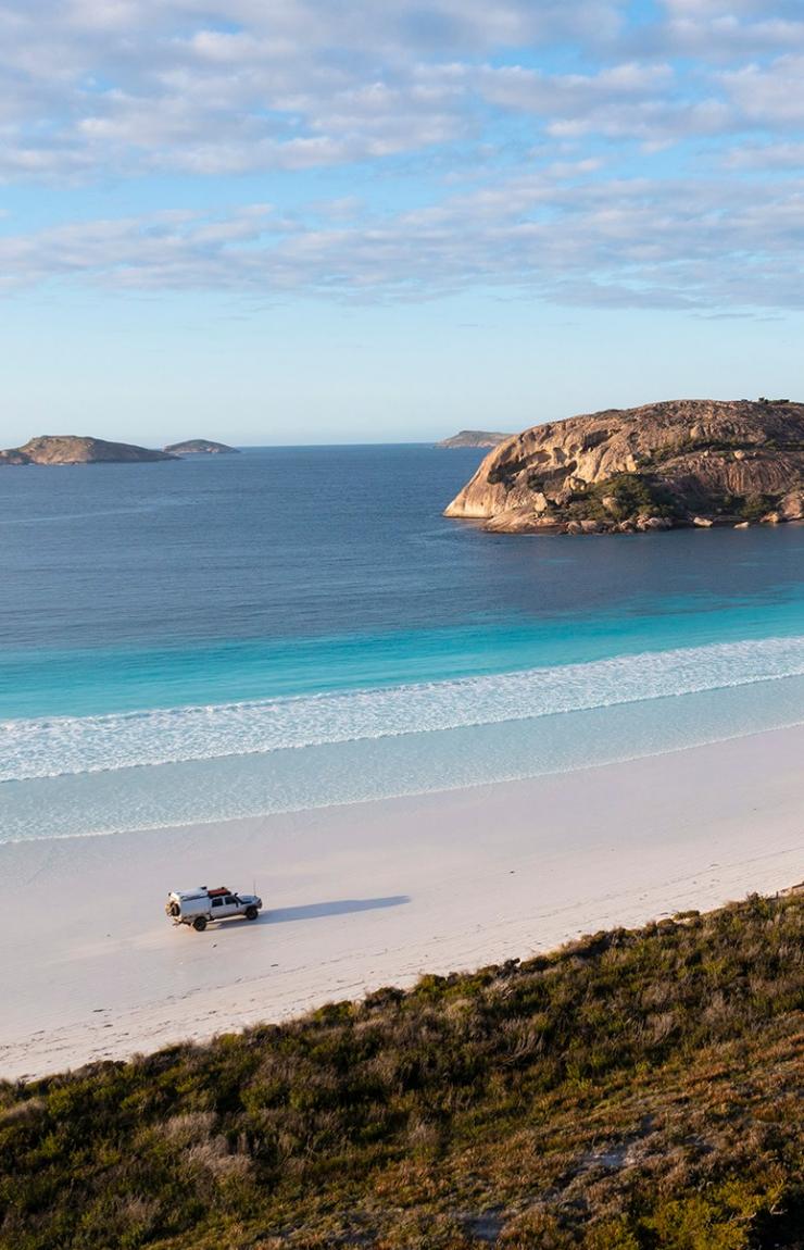 Aerial view of a 4WD driving on a white sand beach with bright blue water at Lucky Bay, Esperance , Western Australia © Tourism Western Australia Aerial view of a 4WD driving on a white sand beach with bright blue water at Lucky Bay, Esperance , Western Australia © Tourism Western Australia