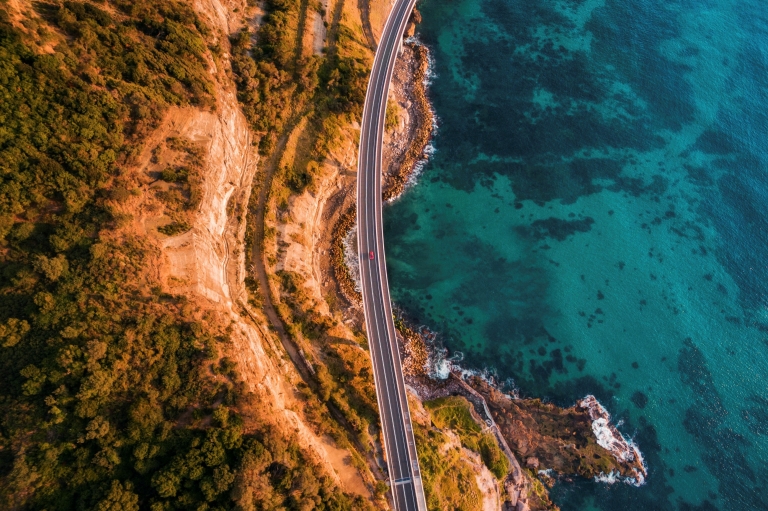 Aerial view of the Sea Cliff Bridge suspended over the ocean in Clifton, New South Wales © Destination NSW Aerial view of the Sea Cliff Bridge suspended over the ocean in Clifton, New South Wales © Destination NSW