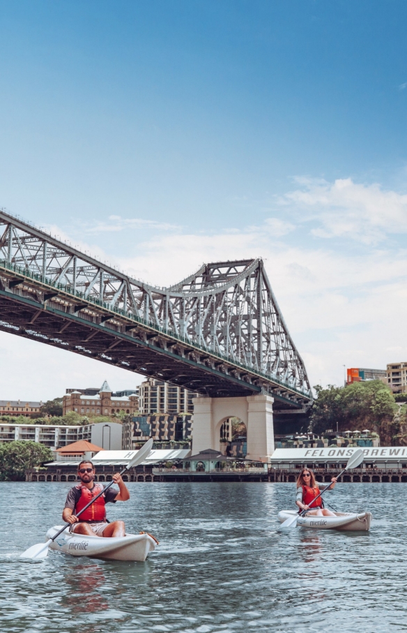 A man and woman kayaking with Riverlife along Brisbane River beneath Story Bridge with Howard Smith Wharves in the background in Brisbane, Queensland © Tourism and Events Queensland A man and woman kayaking with Riverlife along Brisbane River beneath Story Bridge with Howard Smith Wharves in the background in Brisbane, Queensland © Tourism and Events Queensland
