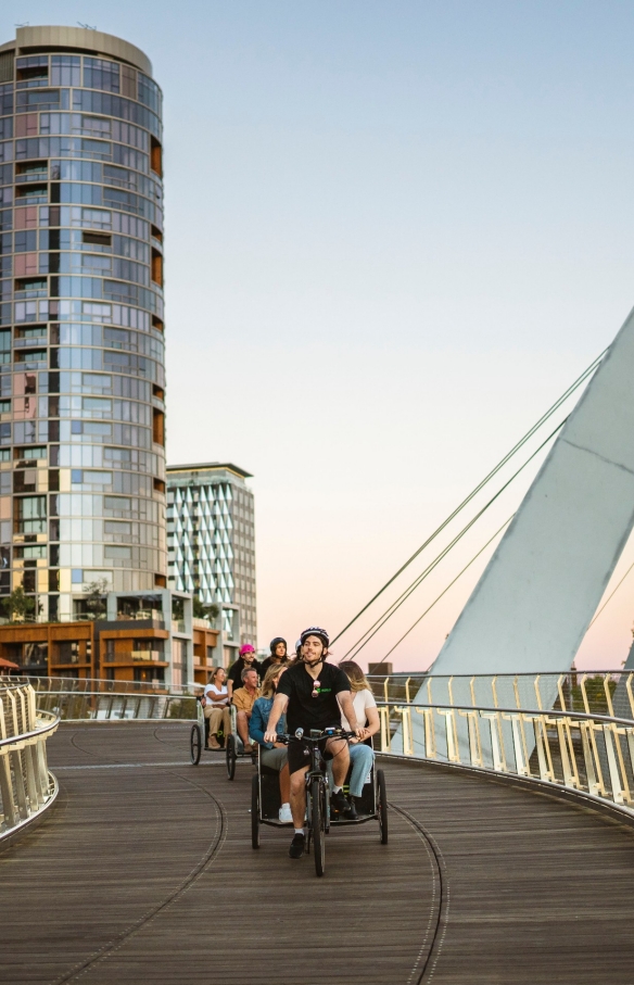 Group of tourists enjoying a rickshaw taxi ride across a bridge at night with Peddle Perth, Perth, Western Australia © Tourism Australia Group of tourists enjoying a rickshaw taxi ride across a bridge at night with Peddle Perth, Perth, Western Australia © Tourism Australia