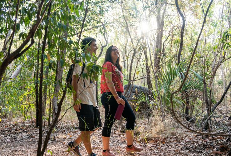 Two friends walking through bushland near Mercure Kakadu Crocodile Hotel during a working holiday, Kakadu, Northern Territory © Tourism NT/Kane Chenoweth