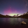 L'aurore australe brille de teintes violettes et vertes derrière les cimes enneigées du Cradle Mountain-Lake St Clair National Park, Tasmanie © Pierre Destribats