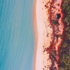 Vue aérienne d'un couple marchant sur une plage lors d'une excursion Salty Dog Adventure Tour dans les îles Whitsunday, Queensland © Tourism and Events Queensland